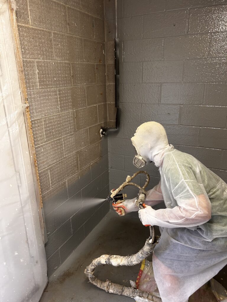 spray foam insulation on cinderblock wall