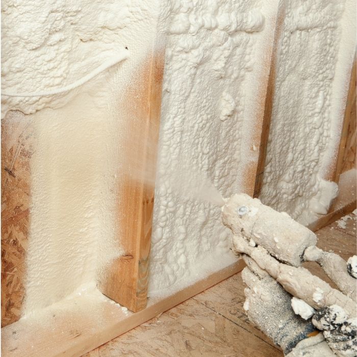 spray foam insulation being sprayed into wall